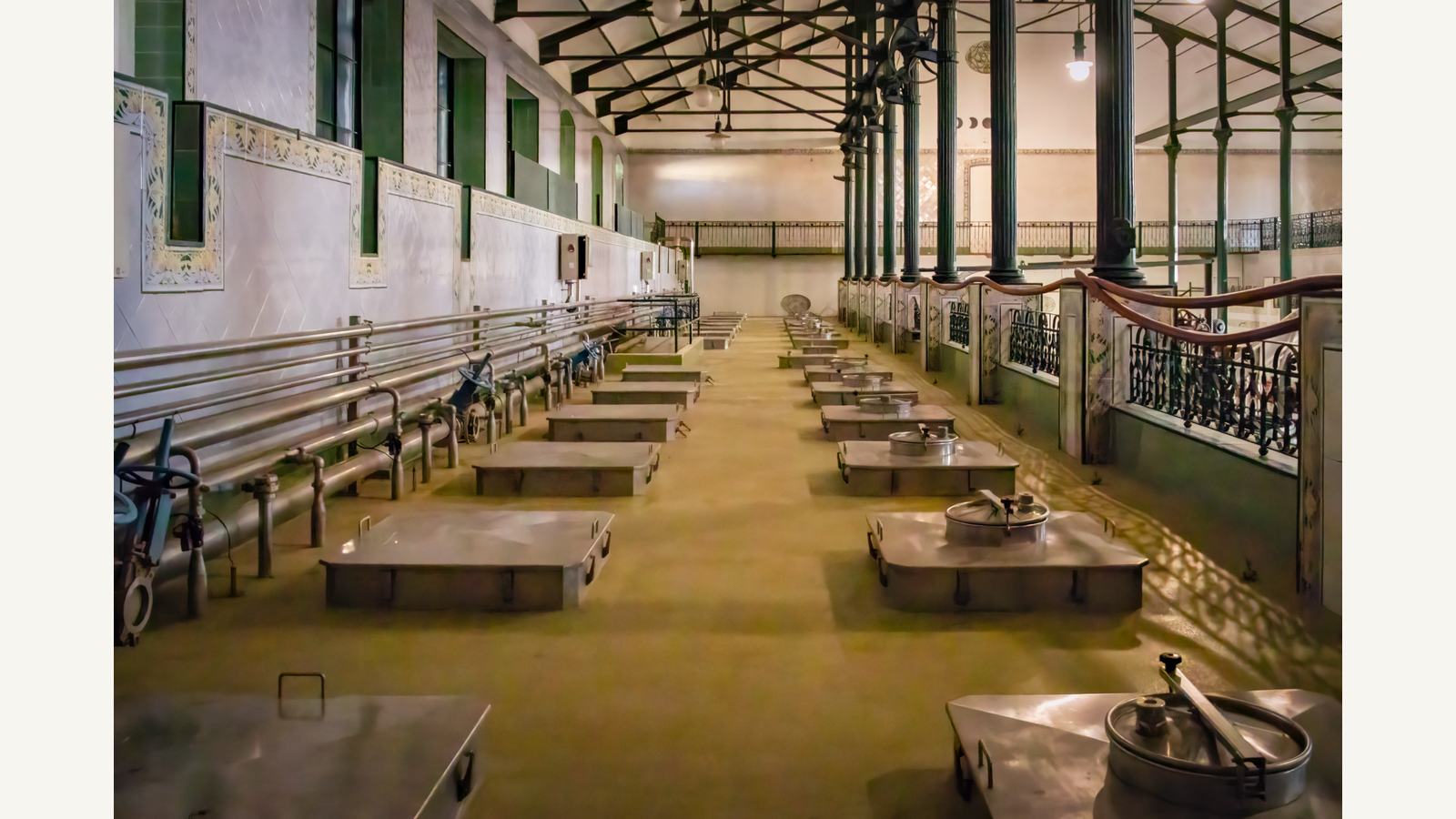 Illustration of a wide historic dairy-processing hall interior with industrial processing space.